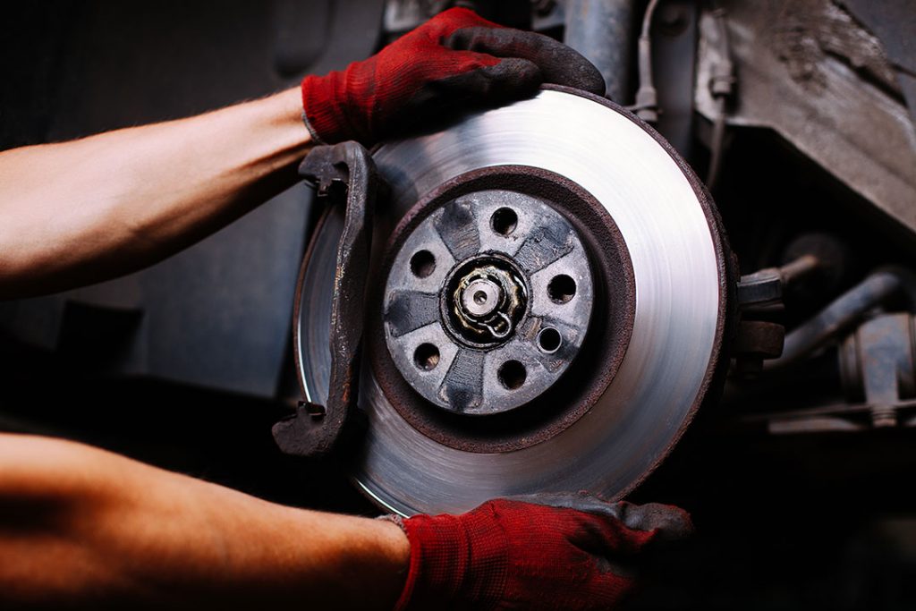 Mechanic repairing a car brake system